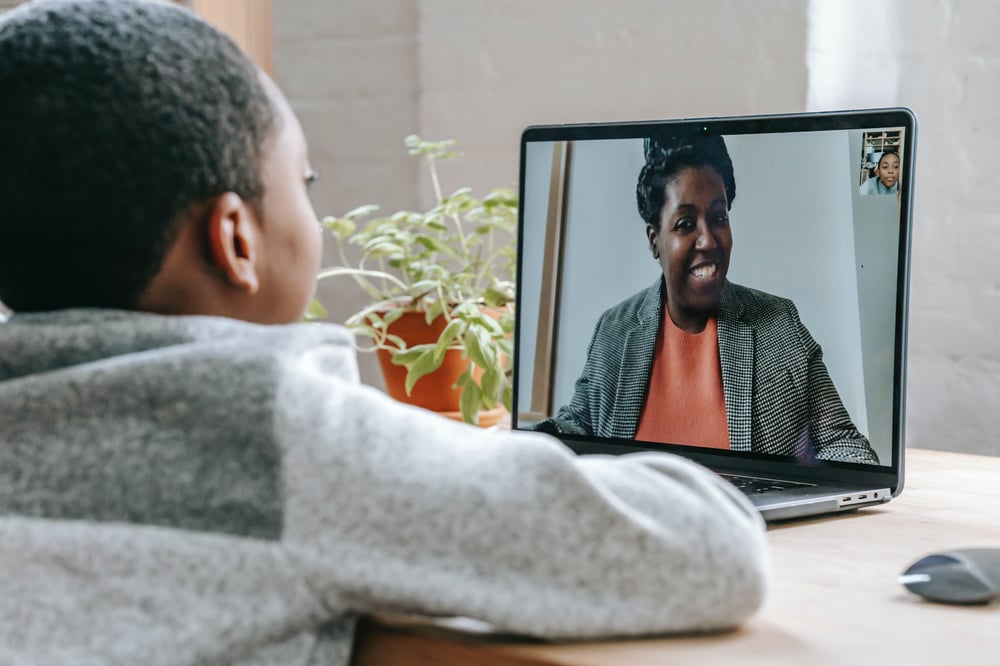 a child talking with a counselor via video chat